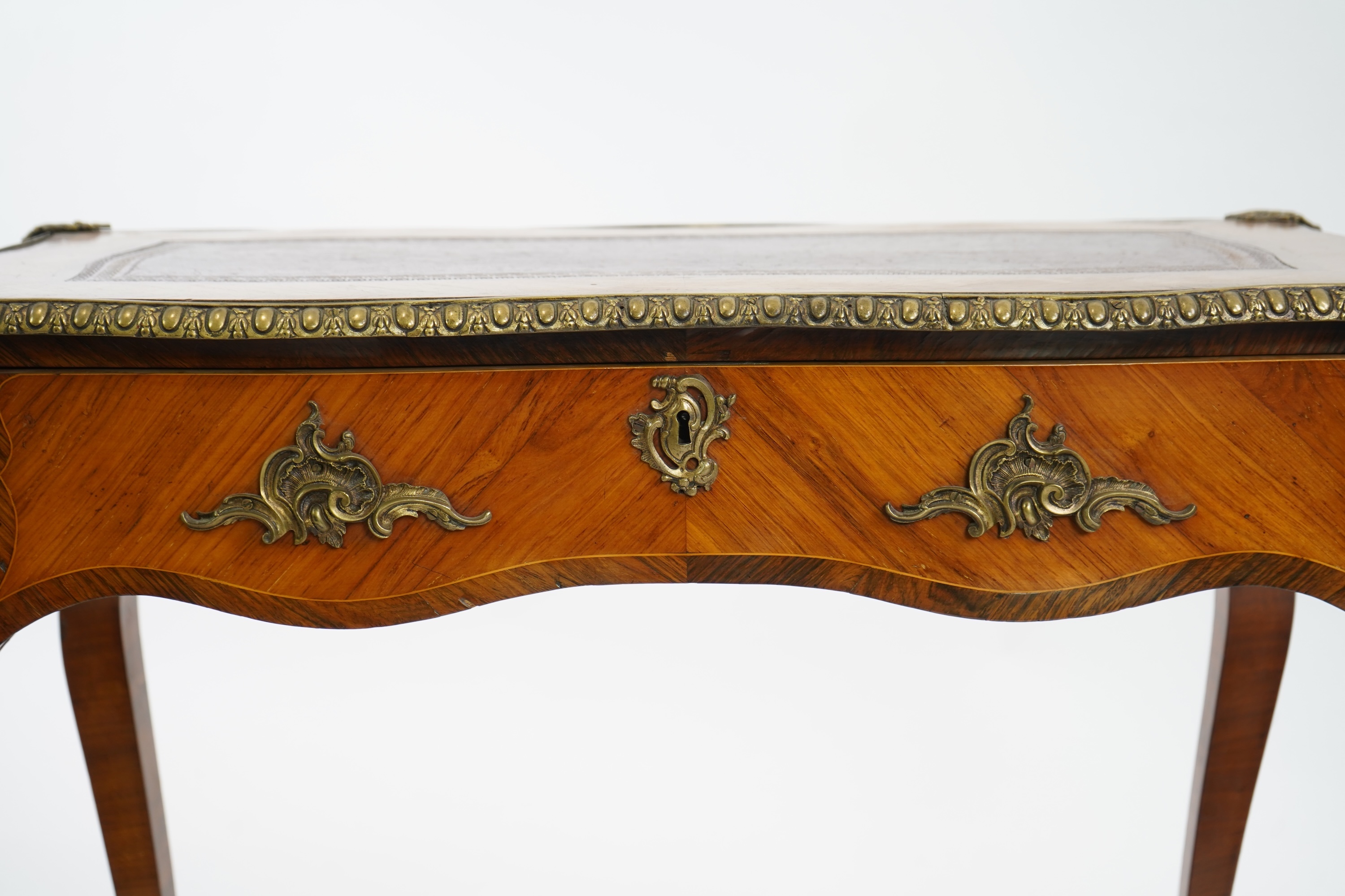 A small Louis XV style gilt metal mounted rosewood and kingwood bureau plat